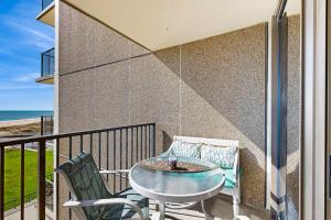 a table and chairs on a balcony with the beach at Sea Colony --- 508 Dover House Rd in Bethany Beach