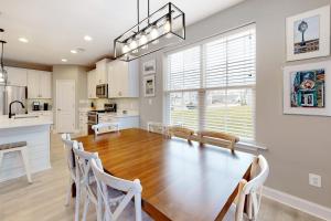 a kitchen with a large wooden table and white chairs at Bishops Landing --- 38480 Carroll Dr in Millville