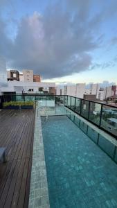 a swimming pool on the roof of a building at Laguna beach house in Cabedelo