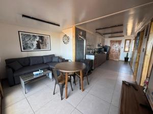 a living room with a couch and a table at Almar House in Guaquen +7 photos