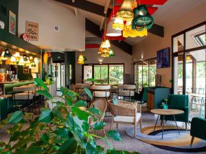 a restaurant with a lot of tables and chairs at ibis Amboise in Amboise