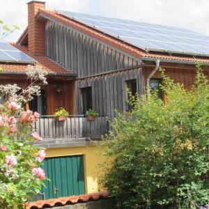 a house with solar panels on the roof at Ferienwohnung "Eifelstueffje" in Mechernich