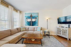 a living room with a couch and a coffee table at Bear Trap Dunes -- 13 Village Green in Ocean View