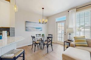 a kitchen and living room with a table and chairs at Bear Trap Dunes -- 13 Village Green in Ocean View