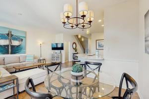 a dining room and living room with a glass table at Bear Trap Dunes -- 13 Village Green in Ocean View