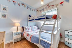 a bedroom with bunk beds and a ladder at 2 Bed in Walcott oc-2282 in Walcott