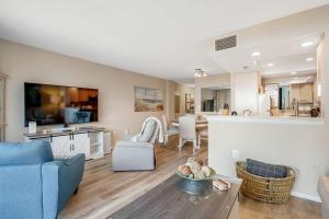 a living room with a blue couch and a kitchen at Sea Colony --- 208 Brandywine House in Bethany Beach