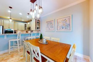a kitchen and dining room with a wooden table and chairs at Bayside Resort 2639zero Seabreeze Lndg in Selbyville