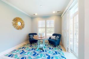 a dining room with a table and chairs and a rug at Bayside Resort 2639zero Seabreeze Lndg in Selbyville