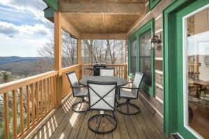 a screened porch with a table and chairs on it at Serenity in Blowing Rock +28 photos