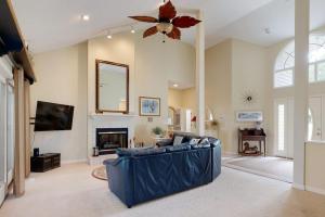 a living room with a blue couch and a fireplace at Salt Pond --- 314 Walkabout Rd in Bethany Beach