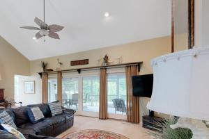 a living room with a couch and a tv at Salt Pond --- 314 Walkabout Rd in Bethany Beach