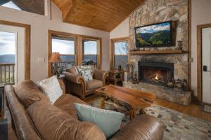 a living room with a couch and a fireplace at Serenity in Blowing Rock