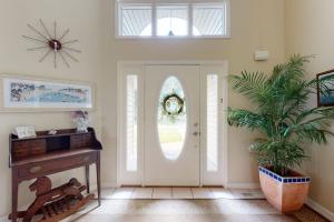 a hallway with a white door and a potted plant at Salt Pond --- 314 Walkabout Rd in Bethany Beach