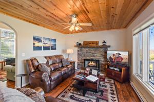 a living room with a couch and a fireplace at A Place Apart in Blowing Rock