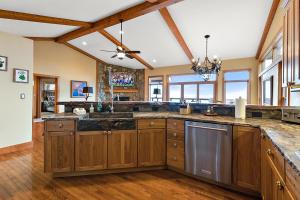 a large kitchen with wooden cabinets and a ceiling at Bella Vista in Beech Mountain