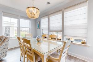 a dining room with a glass table and chairs at Bayside Resort - 28031 Sea Dock in Selbyville