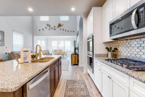 a kitchen with white cabinets and a counter top at Bayside Resort - 28031 Sea Dock in Selbyville