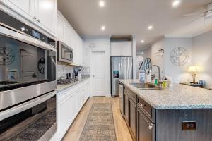 a large kitchen with white cabinets and a sink at Bayside Resort - 28031 Sea Dock in Selbyville +29 photos