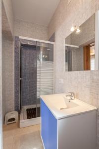 a bathroom with a sink and a shower with a mirror at Salado Apartment in Seville