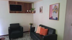 a living room with a couch and a chair at Tropical Haus CR - El Manglar in Puerto Jiménez