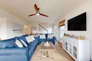 a living room with a blue couch and a flat screen tv at South Bethany --- 106 Brandywine Drive in Bethany Beach