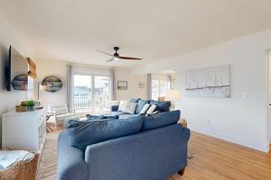 a blue couch in a living room with a ceiling fan at South Bethany --- 106 Brandywine Drive in Bethany Beach