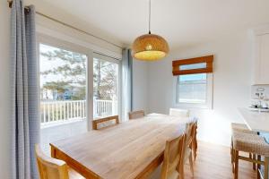 a dining room with a large wooden table and chairs at South Bethany --- 106 Brandywine Drive in Bethany Beach