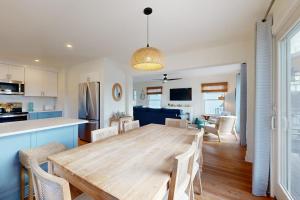 a dining room and kitchen with a wooden table and chairs at South Bethany --- 106 Brandywine Drive in Bethany Beach