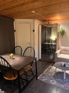 a living room with a table and chairs and a couch at Gästhus med båtplats in Kvicksund