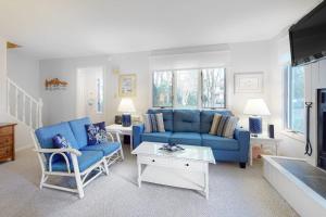 a living room with a blue couch and chairs at Bethany Pines -- 412 Bethany Drive in Bethany Beach