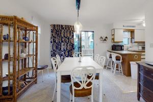 a kitchen and dining room with a white table and chairs at Bethany Pines -- 412 Bethany Drive in Bethany Beach