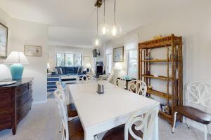 a dining room and living room with a table and chairs at Bethany Pines -- 412 Bethany Drive in Bethany Beach