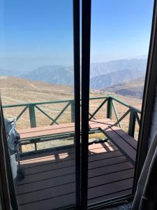 a door to a balcony with a view of the mountains at Refugio de Montaña, excepcional in El Colorado