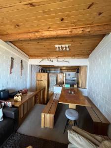a living room with a wooden table and a couch at Refugio de Montaña, excepcional in El Colorado