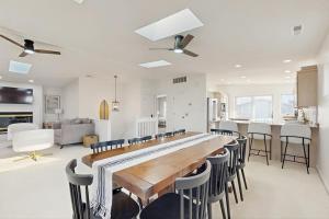 a kitchen and living room with a long table and chairs at South Bethany --- 309 W 2nd St in Bethany Beach