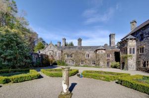 an old castle with a garden in front of it at 1 Bed in Llanrwst oc-wag232 in Llanrwst