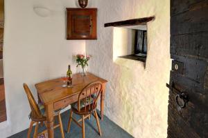 a small table with two chairs and a bottle of wine at 1 Bed in Llanrwst oc-wag232 in Llanrwst +11 photos