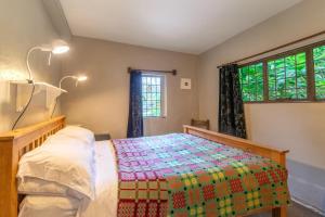 a bedroom with a bed with a colorful blanket at 1 Bed in Llanrwst oc-wag232 in Llanrwst