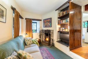 a living room with a couch and a fireplace at 1 Bed in Llanrwst oc-wag232 in Llanrwst