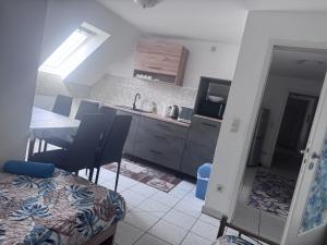 a kitchen with a table and chairs and a dining room at Monteurwohnung Weigl in Großmehring