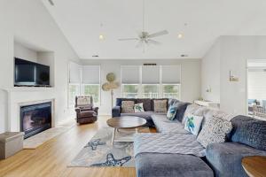 a living room with a blue couch and a fireplace at Bear Trap Dunes --- 124 October Glory Ave Unit #B in Ocean View