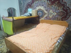 a bed in a room with a desk and a bed sidx sidx sidx at Алима in Ottuk