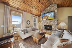a living room with a couch and a fireplace at Alpine Retreat in Seven Devils