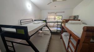 a dorm room with two bunk beds and a window at Villa Jardín Con piscina y jacuzzi in Bonda +15 photos