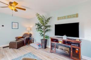 a living room with a flat screen tv on a wall at The Reservation --- 38601 Indian Trail in Ocean View