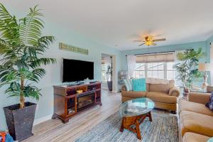 a living room with a couch and a tv at The Reservation --- 38601 Indian Trail in Ocean View