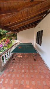 a ping pong table sitting on a patio at Villa Jardín Con piscina y jacuzzi in Bonda