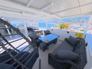 a balcony with a table and chairs and a view of the water at Merhaba Pansiyon in Bodrum City
