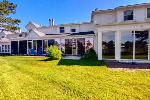 a large white house with large windows and a yard at Mallard Lakes --- 38082 Mockingbird Ln Unit #48 in Selbyville